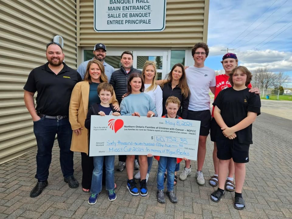Miggy Cup organizers and supporters present a $60,752.35 donation to NOFCC
