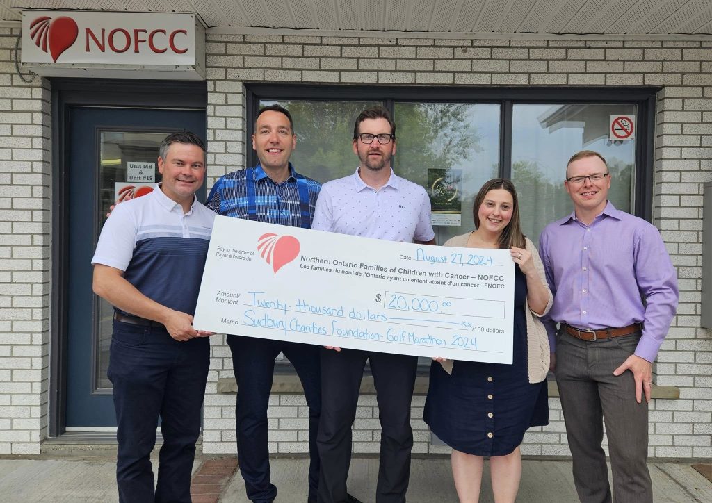 Sudbury Charities Foundation representatives present a donation to NOFCC outside the NOFCC office.