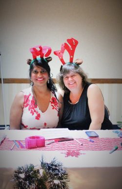 Vicky and Areeda volunteering at a community fundraising table